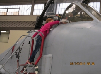 Grand daughter not bashful about asking questions from pilot of a A10 Warthog.